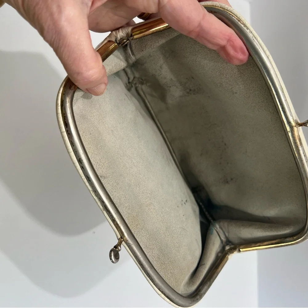Vintage pair of white leather clutches, one is 70’s with great blk/white lining